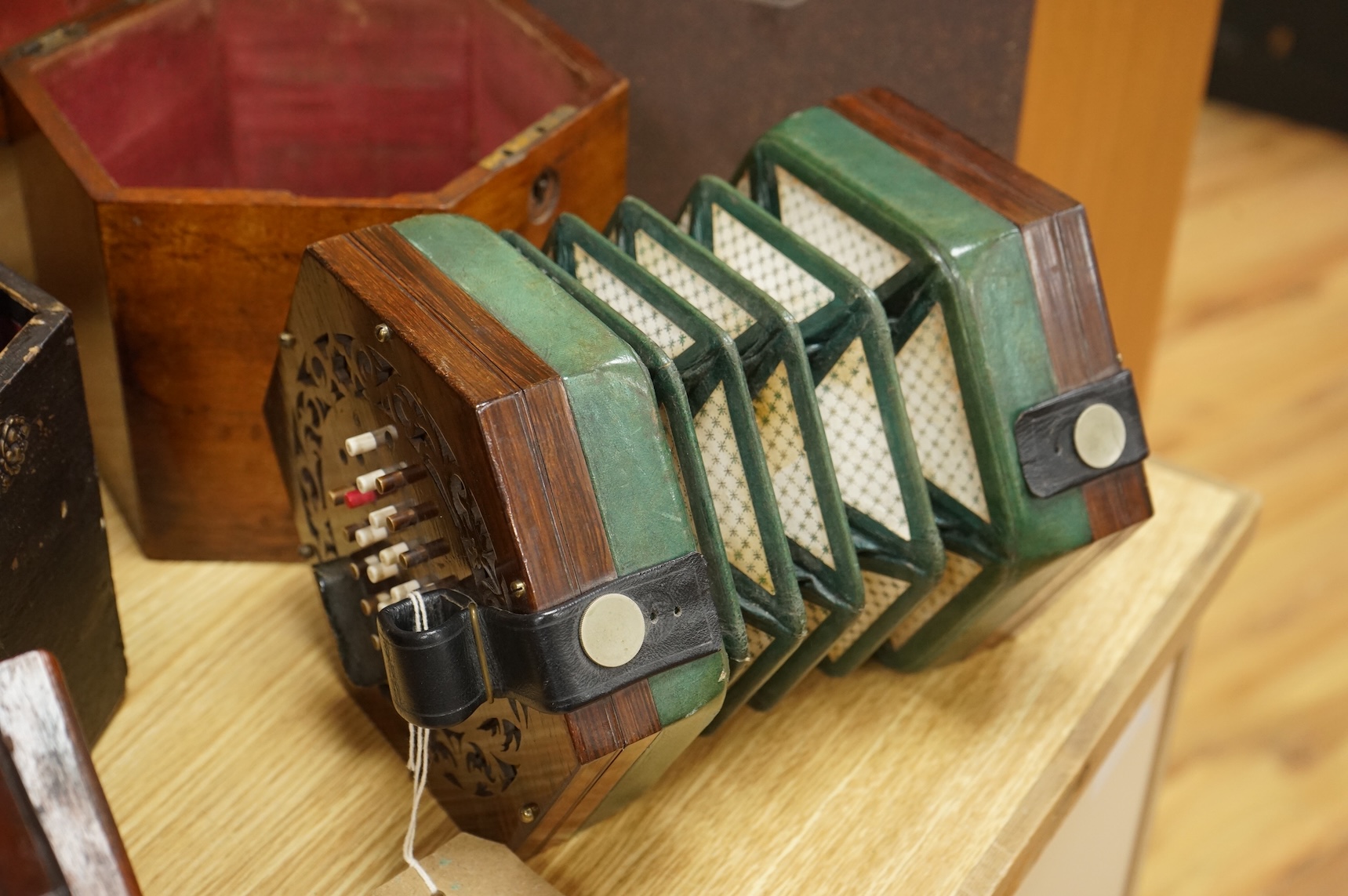 A mahogany cased concertina by Rock Chidley, 135, High Holborn, London, with the rosewood body and numbered 566, CITES Submission reference QML3VKXT